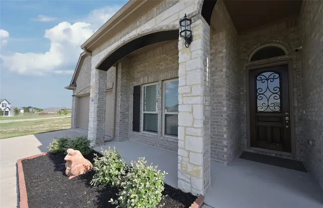 a kitchen with a dining table chairs and white cabinets