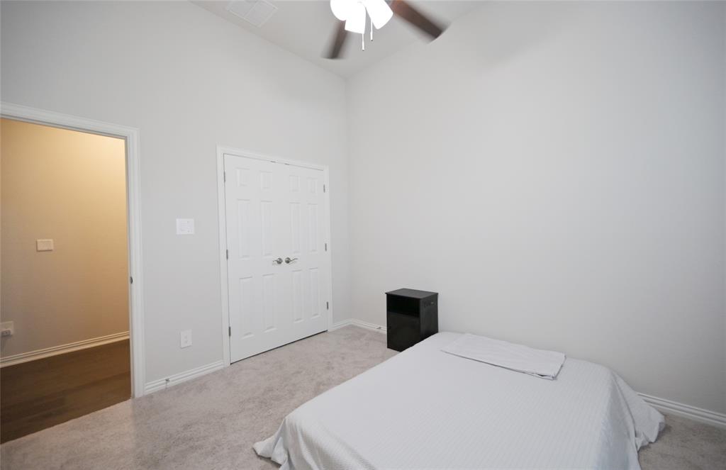 1802 Ranch View Drive Cedar Hill, TX 75104 - Photo 31 of 40 a bedroom with a bed and a ceiling fan