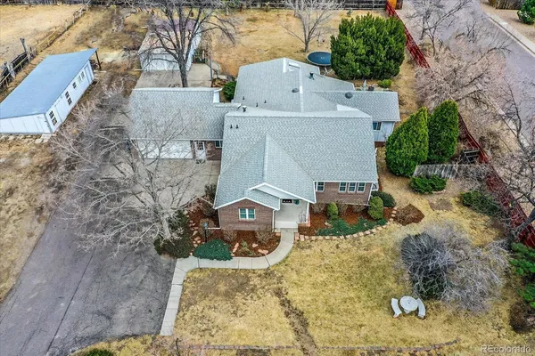 an aerial view of a house with a yard