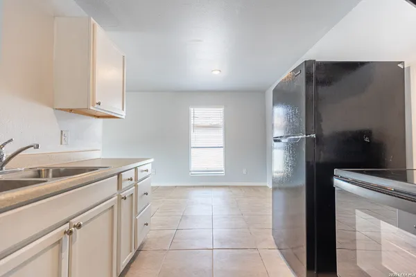 a kitchen with a sink and a refrigerator