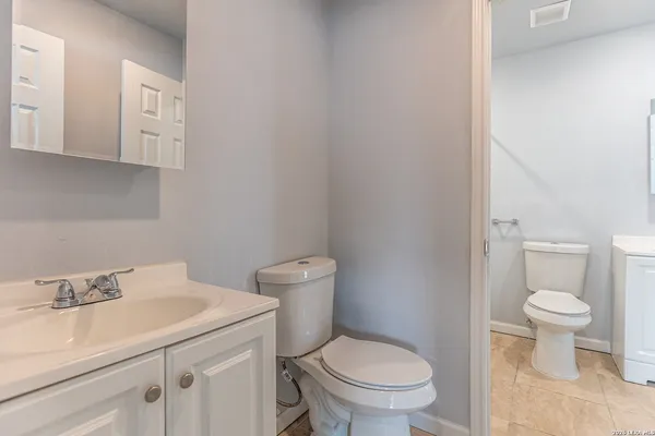 a white toilet sitting next to a bathroom sink