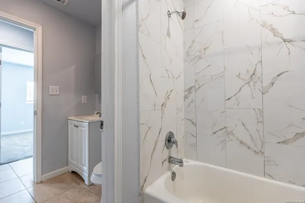 a bathroom with shower and bathtub