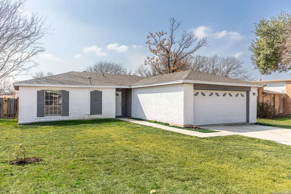 a view of a house with a yard and garage