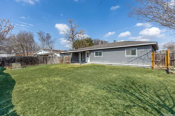 a backyard of a house with table and chairs