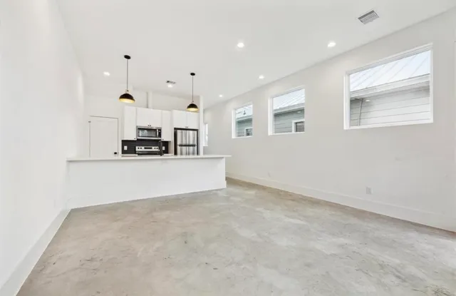 a view of kitchen with refrigerator sink and microwave