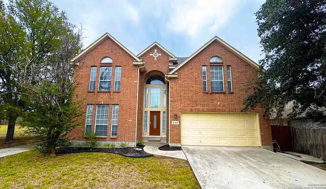 a front view of a house with a yard and garage