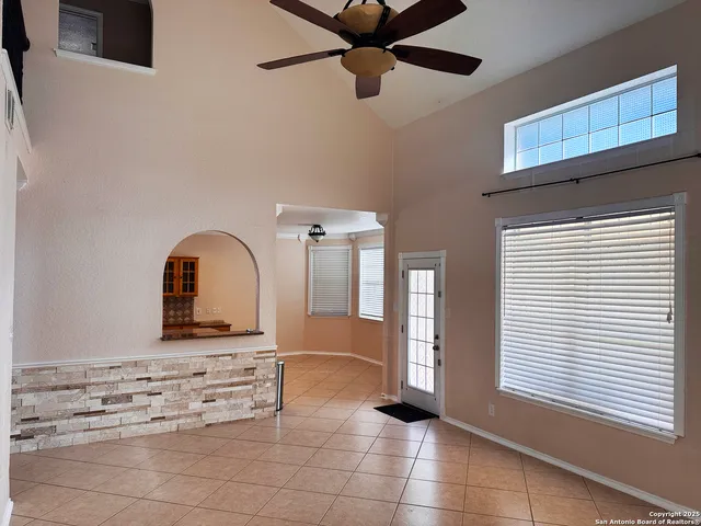 a view of a hallway with wooden floor and a bathroom