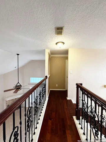 a view of a room with a ceiling fan