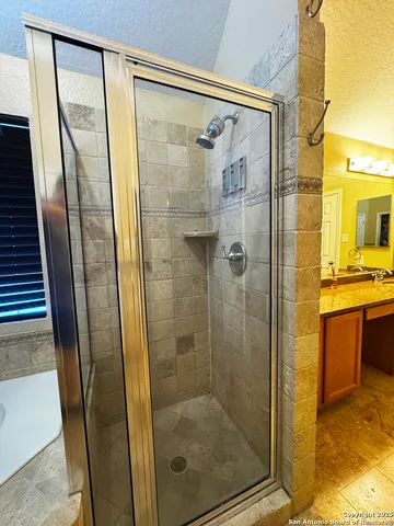 a large bathroom with a tub and sink