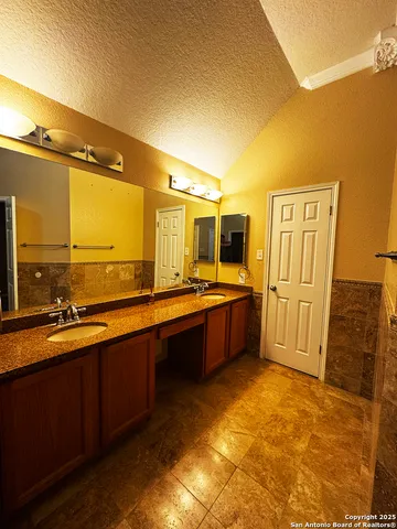 a view of a livingroom with wooden floor and a bathroom