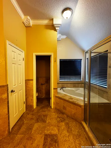 a bathroom with a sink and mirror with bathtub