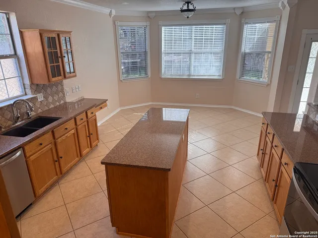 a kitchen with stainless steel appliances granite countertop a sink stove and cabinets