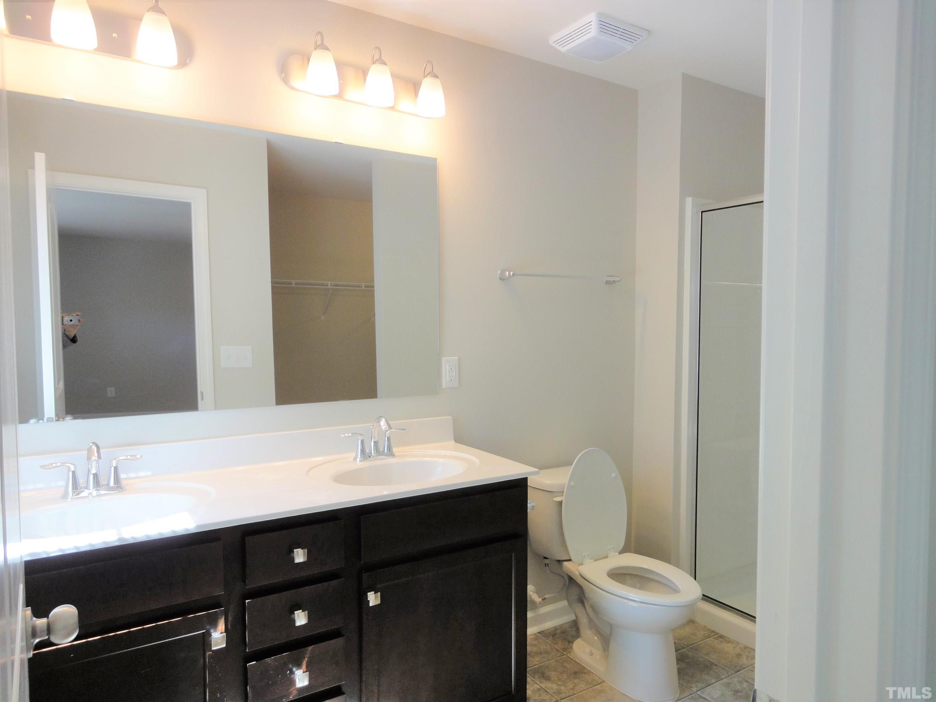 565 Metro Station Apex, NC 27502 - Photo 19 of 29 a bathroom with a sink and a mirror