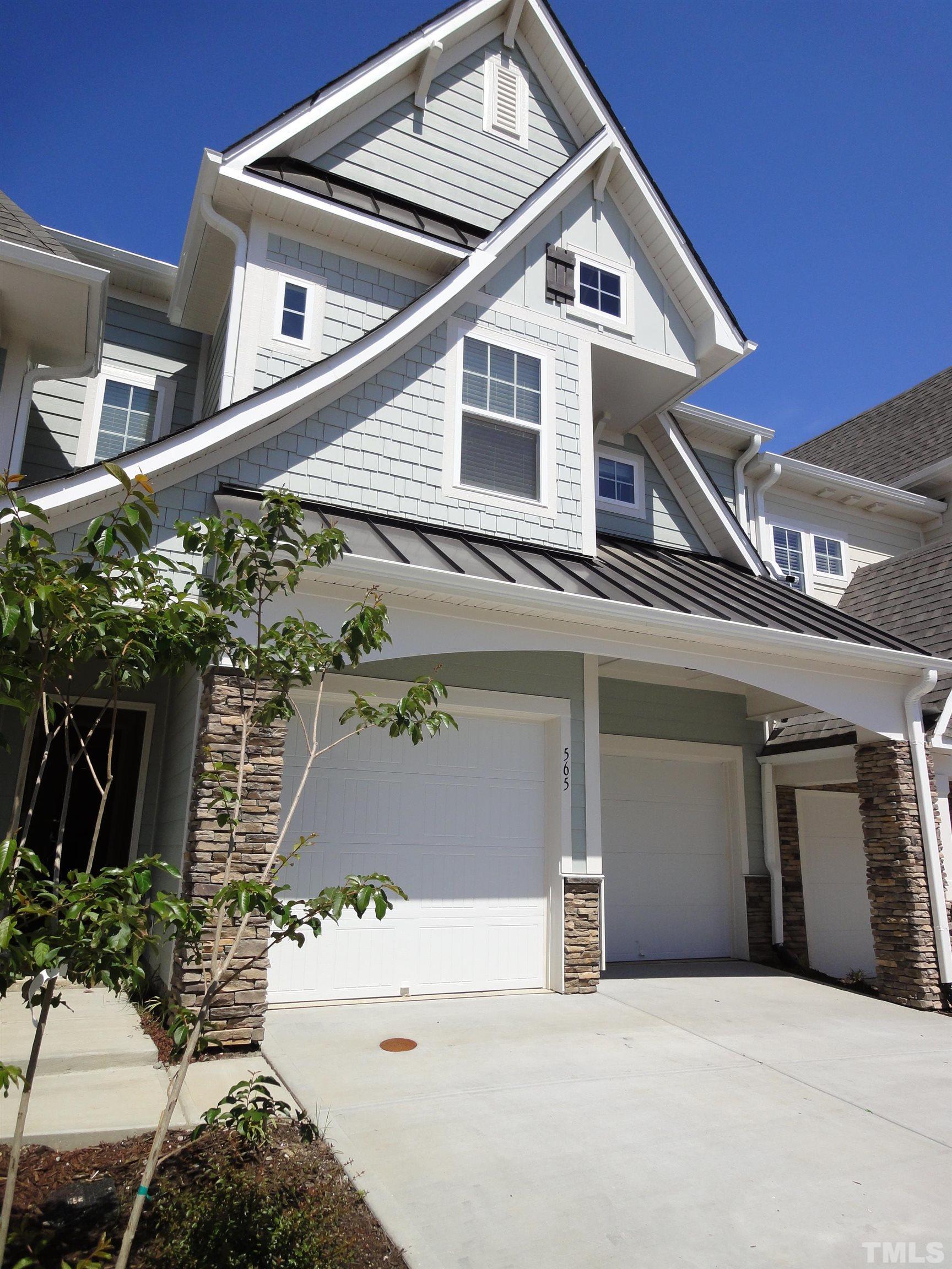 565 Metro Station Apex, NC 27502 - Photo 2 of 29 a view of a house with a garage and balcony