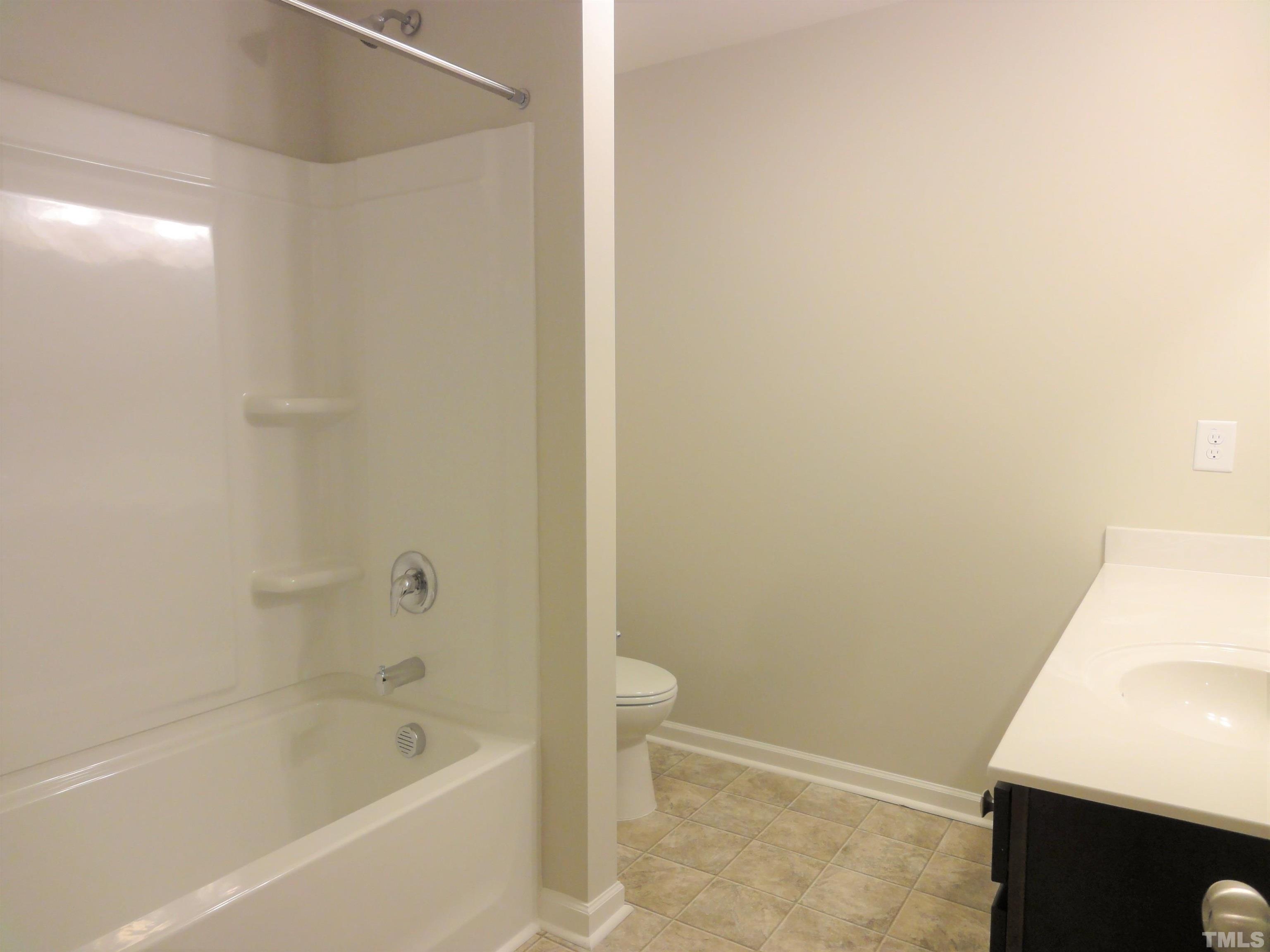 565 Metro Station Apex, NC 27502 - Photo 21 of 29 a bathroom with a bathtub