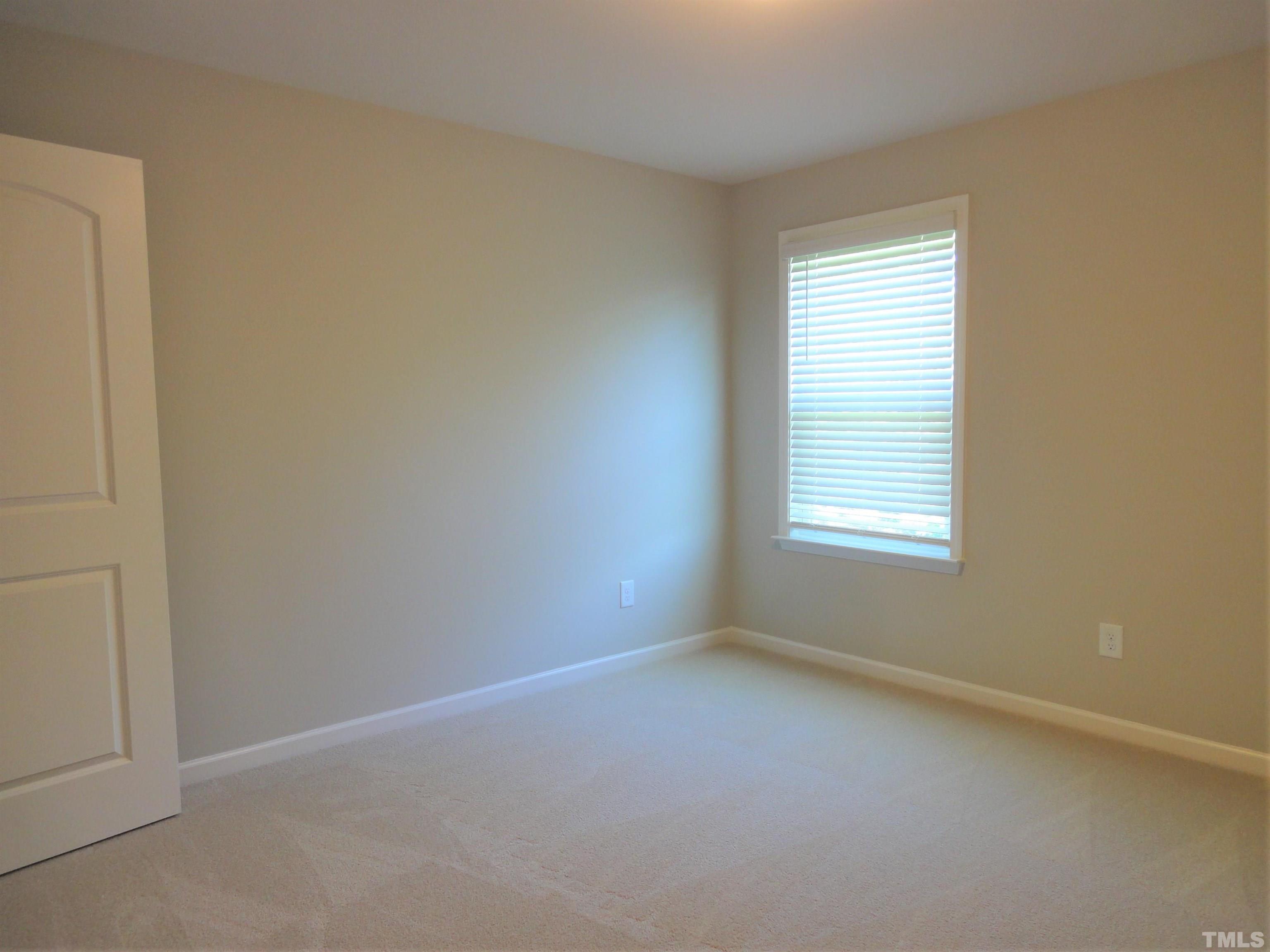 565 Metro Station Apex, NC 27502 - Photo 22 of 29 an empty room with a window