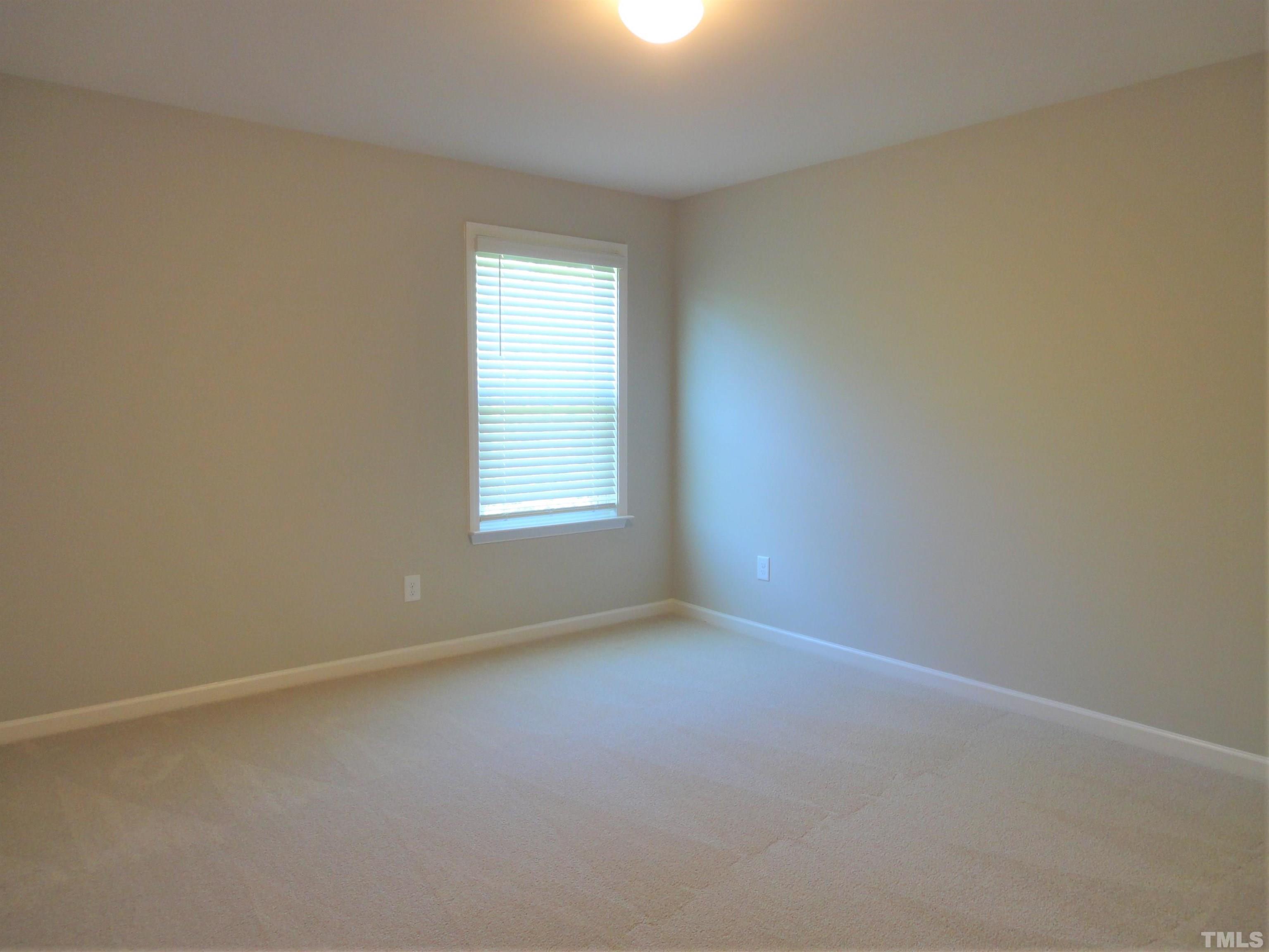 565 Metro Station Apex, NC 27502 - Photo 23 of 29 an empty room with a window