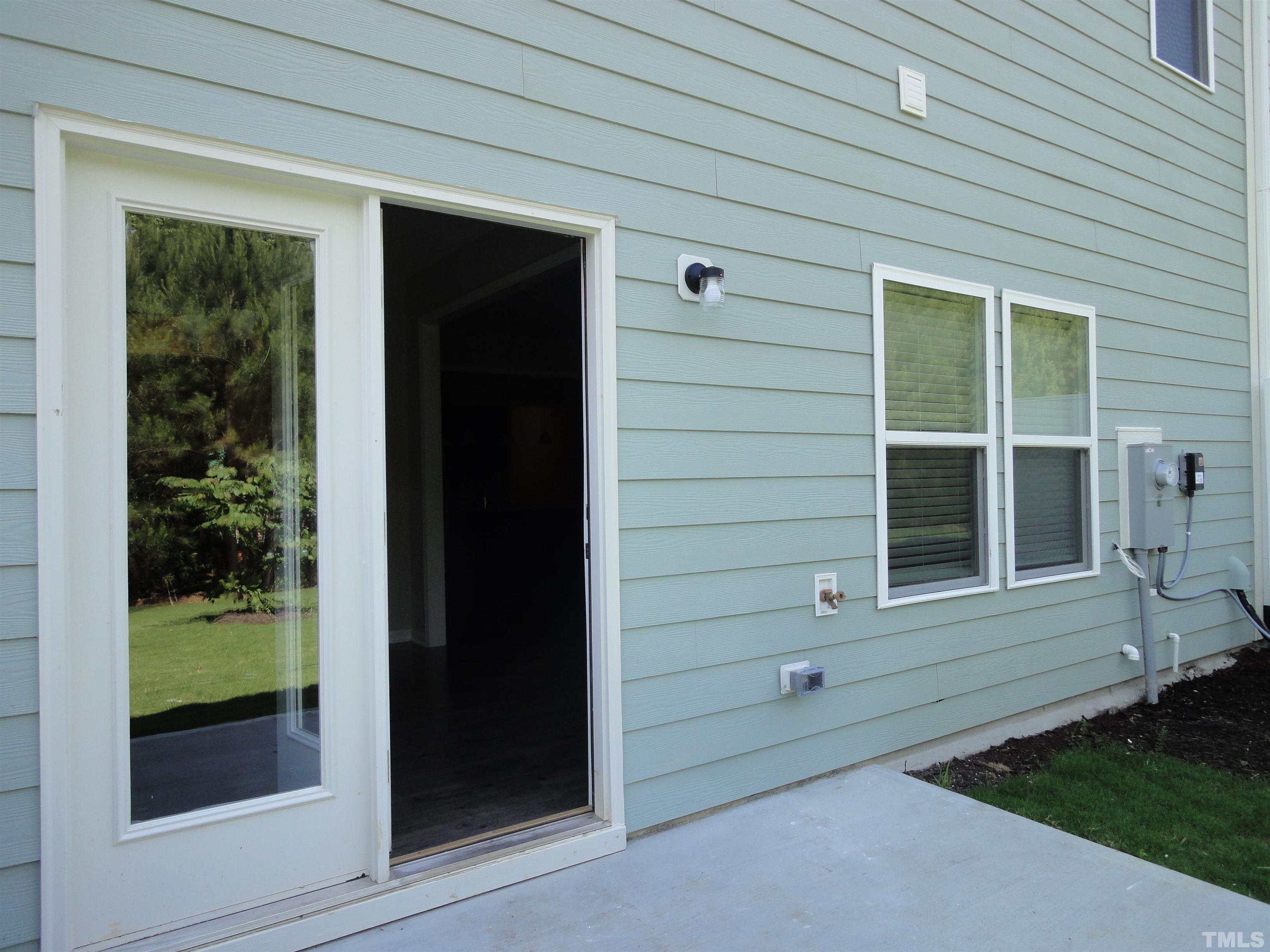 565 Metro Station Apex, NC 27502 - Photo 24 of 29 a view of house exterior with open window and door
