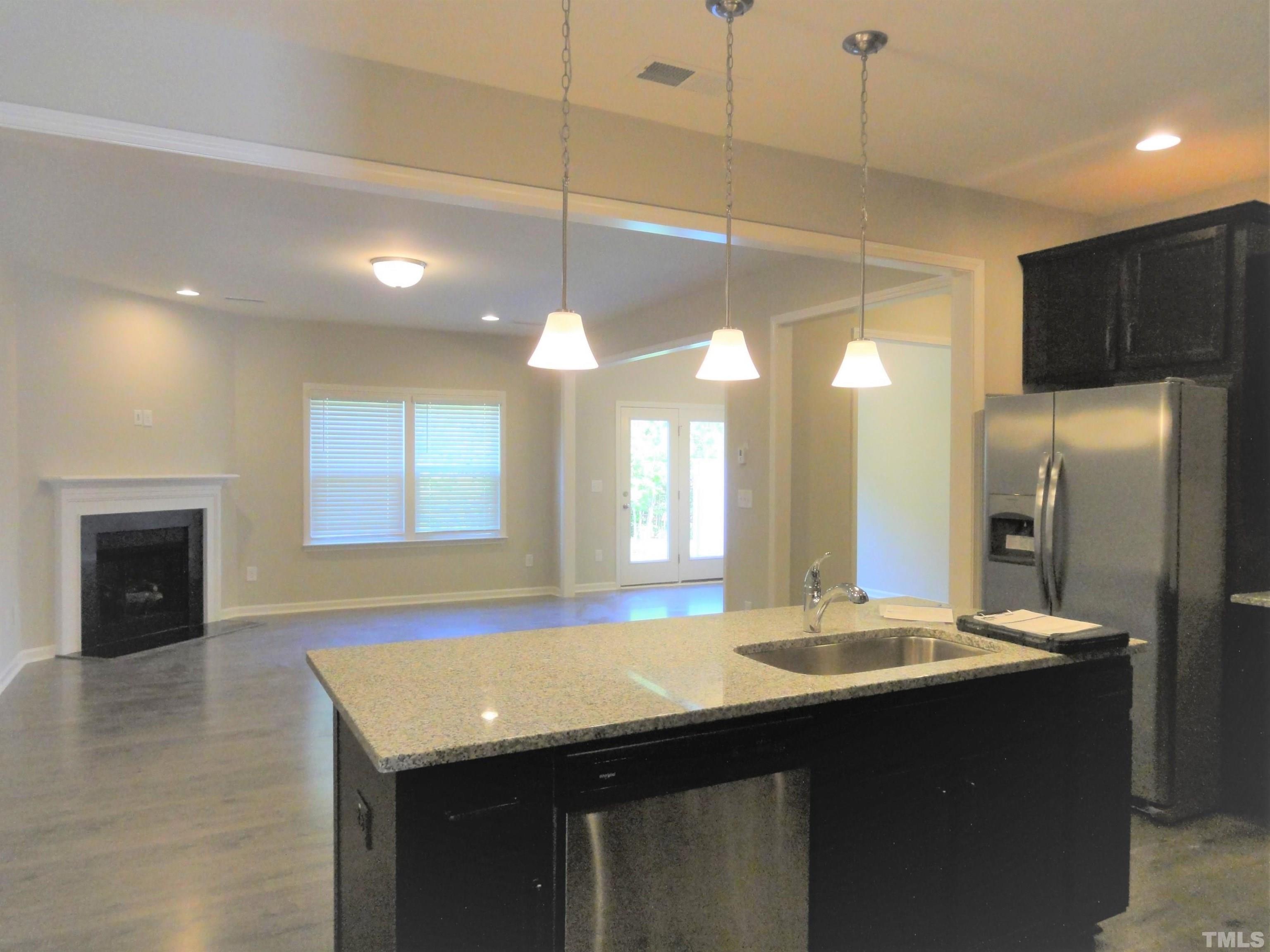 565 Metro Station Apex, NC 27502 - Photo 8 of 29 a bathroom with a sink a large mirror and a shower