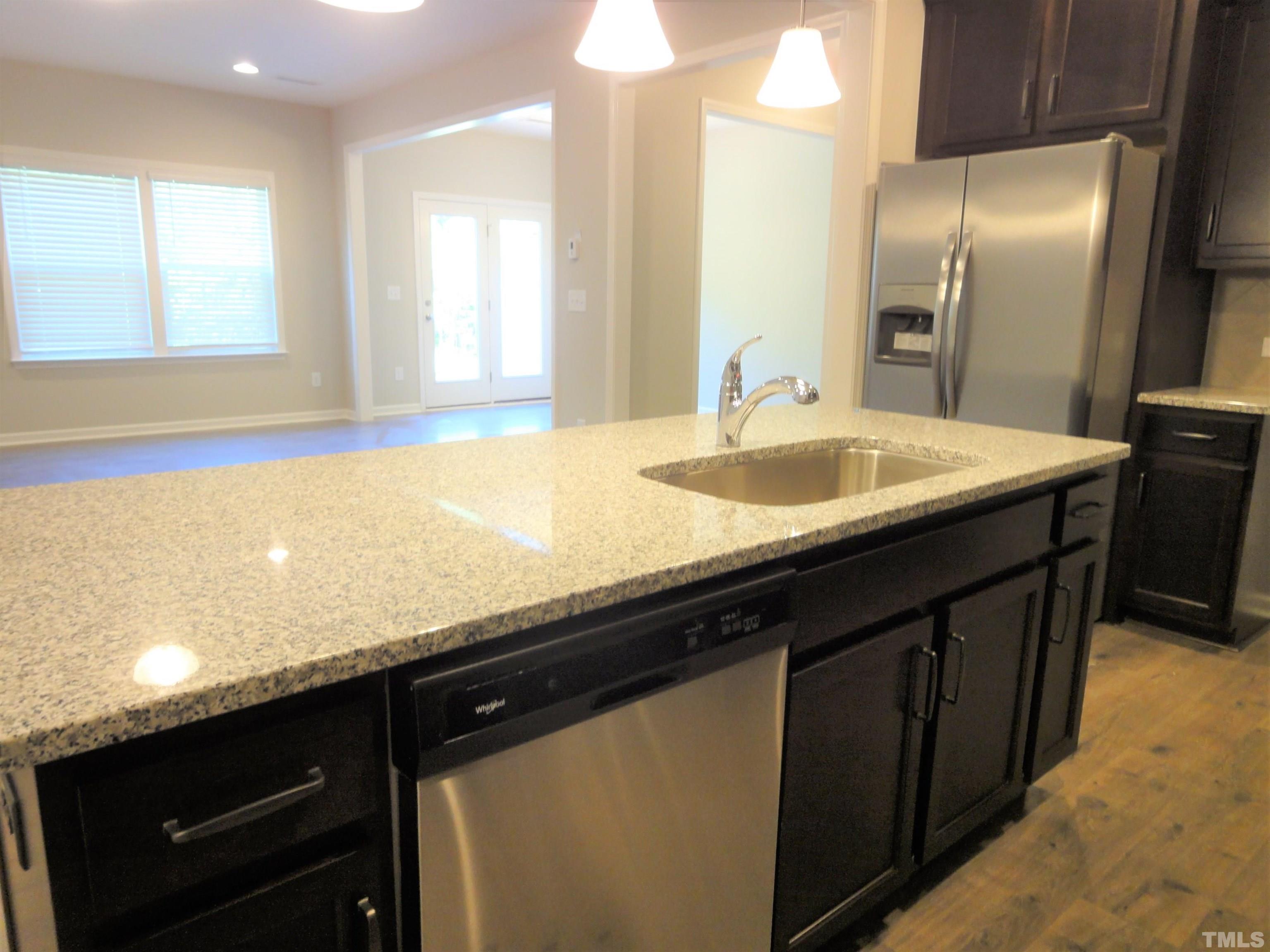 565 Metro Station Apex, NC 27502 - Photo 9 of 29 a kitchen with a sink and a refrigerator