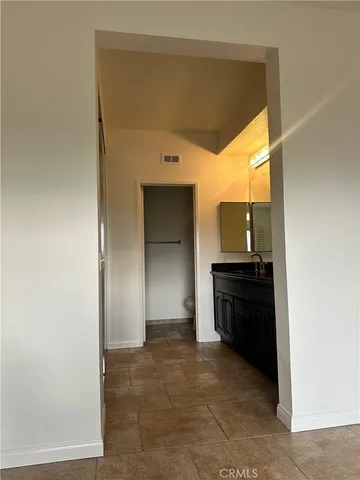 a view of a patio with chairs and potted plants