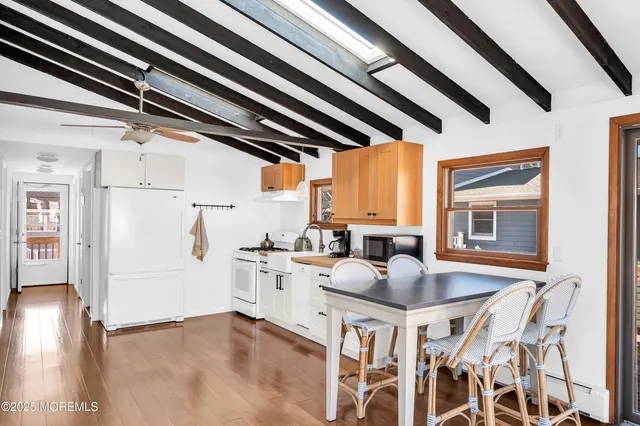 a kitchen with stainless steel appliances kitchen island granite countertop furniture and a refrigerator