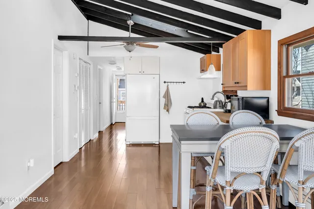 a kitchen with appliances cabinets and chair