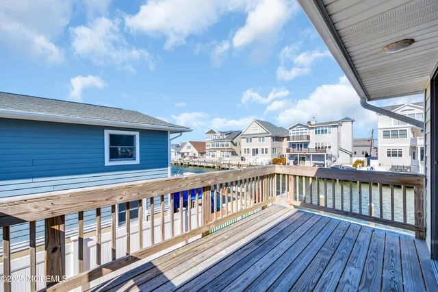 a view of a roof deck with table and chairs under an umbrella