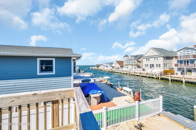 a balcony with chairs and a table