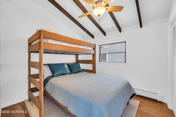 a bed sitting in a bedroom next to a window
