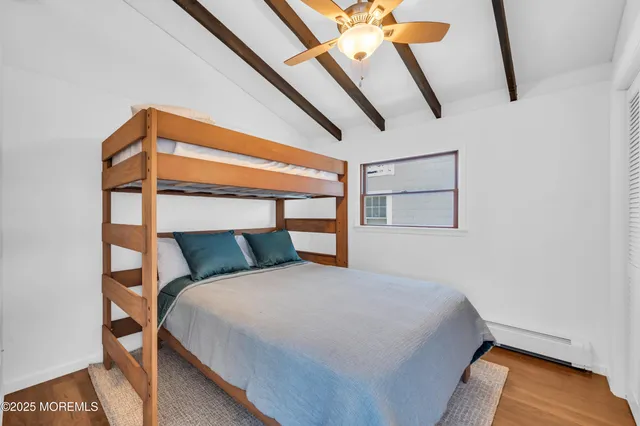 a bed sitting in a bedroom next to a window