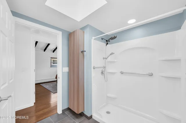 a bathroom with a bathtub and a shower