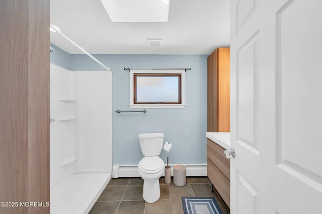 a bathroom with a toilet sink and a mirror