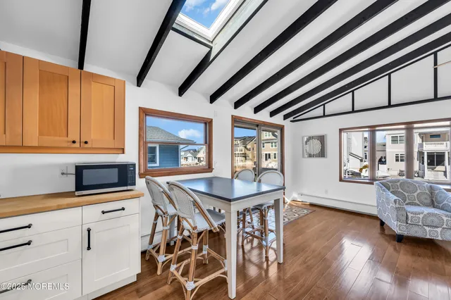a dining room with furniture and wooden floor