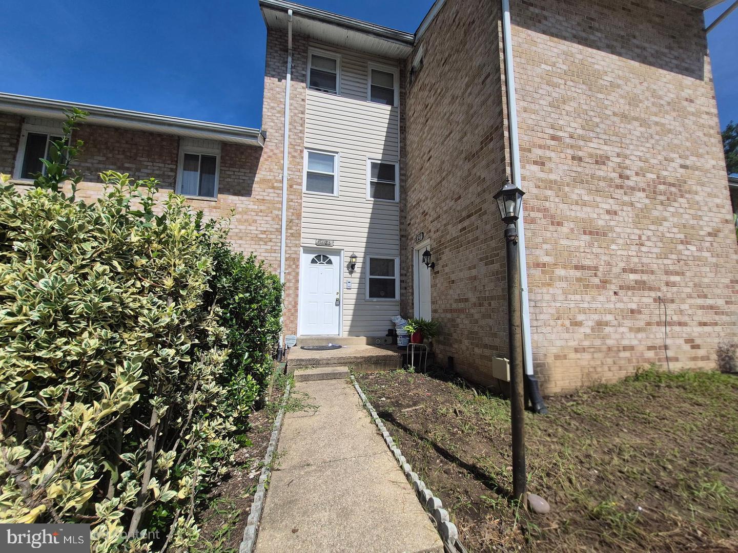 a pathway of a house with backyard
