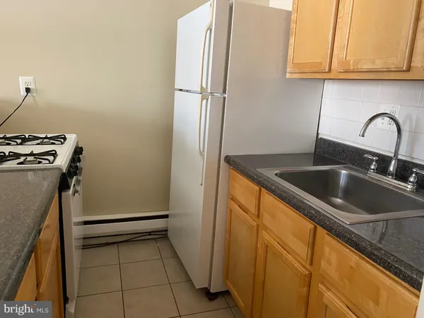 a kitchen with refrigerator and cabinets