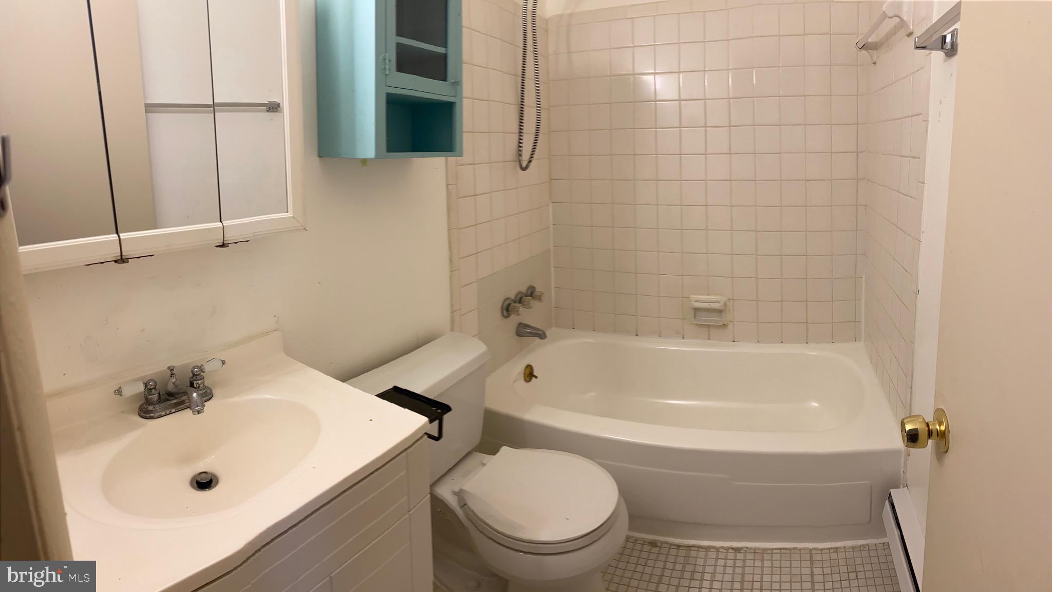 9323 Matador Road, Unit A Columbia, MD 21045 - Photo 9 of 9 a white bath tub sitting next to a white sink and a toilet