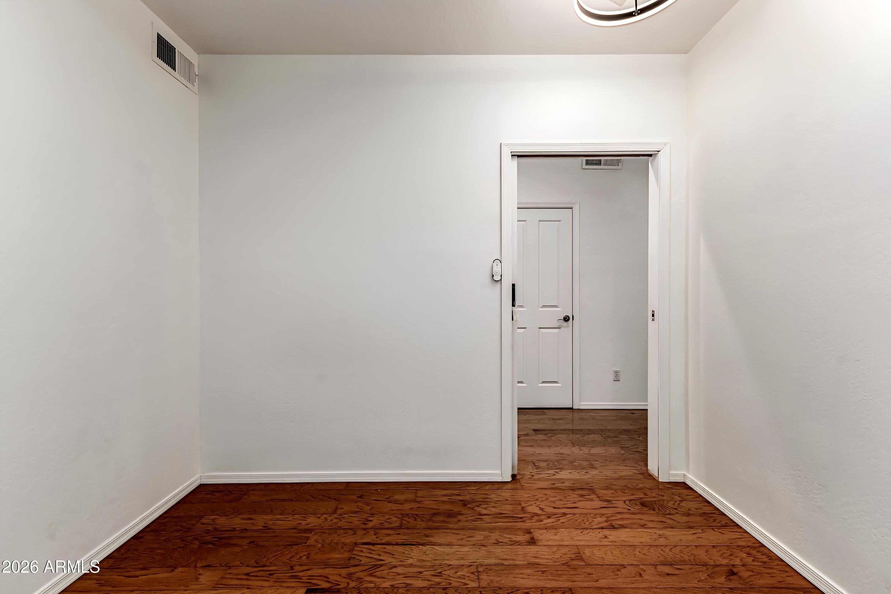 4208 South Sawmill Road Gilbert, AZ 85297 - Photo 36 of 46 a view of an empty room with wooden floor
