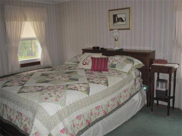 2115 Calkins Road Palmer, MA 01069 - Photo 6 of 22 a bed sitting in a bedroom next to a window