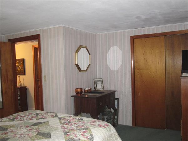 2115 Calkins Road Palmer, MA 01069 - Photo 9 of 22 a bedroom with a bed and a mirror