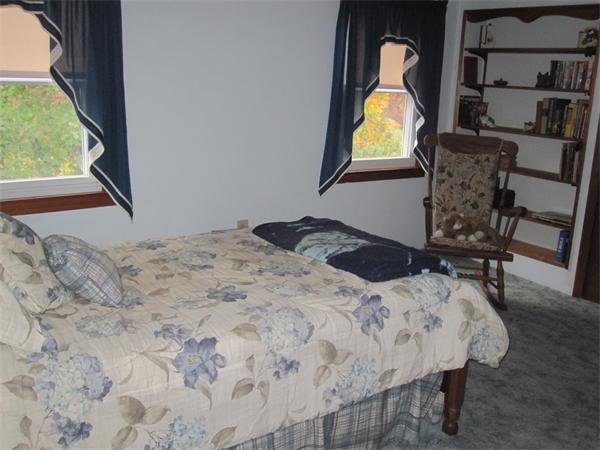 2115 Calkins Road Palmer, MA 01069 - Photo 10 of 22 a bedroom with a bed and dresser with wooden floor