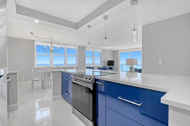 a kitchen with stainless steel appliances a sink stove and cabinets