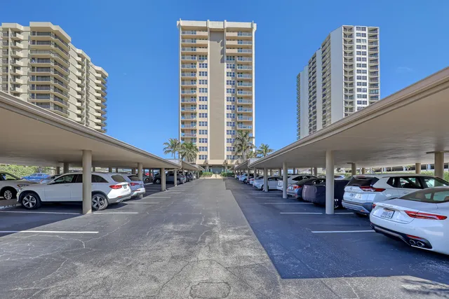 a view of a hallway with dining area and chandelier