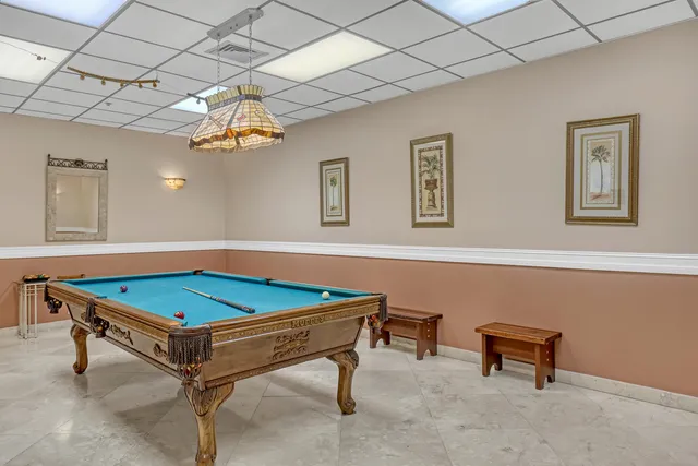 a living room with furniture a flat screen tv and a bookshelf