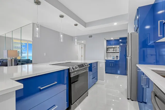a kitchen with stainless steel appliances granite countertop a stove a sink and a refrigerator