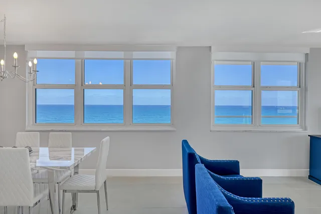 a blue chair sitting in front of a window