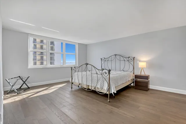 a spacious bedroom with a bed and a window