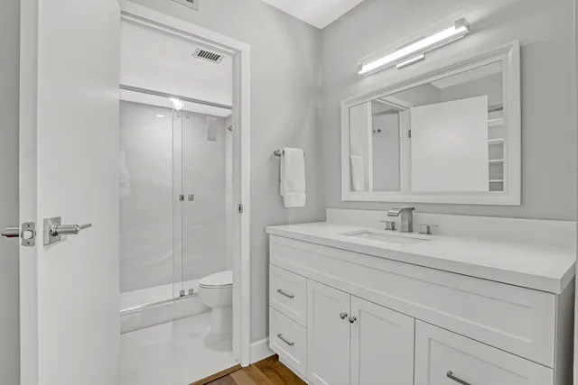 a bathroom with a granite countertop sink mirror and