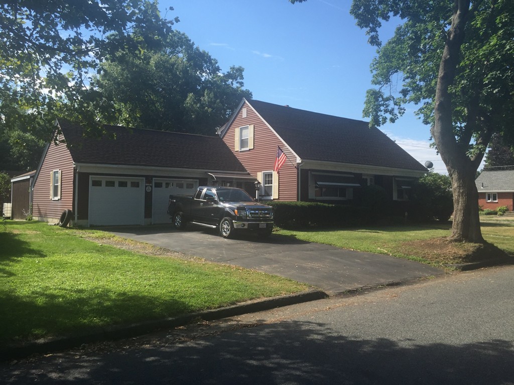 79 Haller Street Springfield, MA 01151 - Photo 1 of 26 a front view of a house with a yard and garage