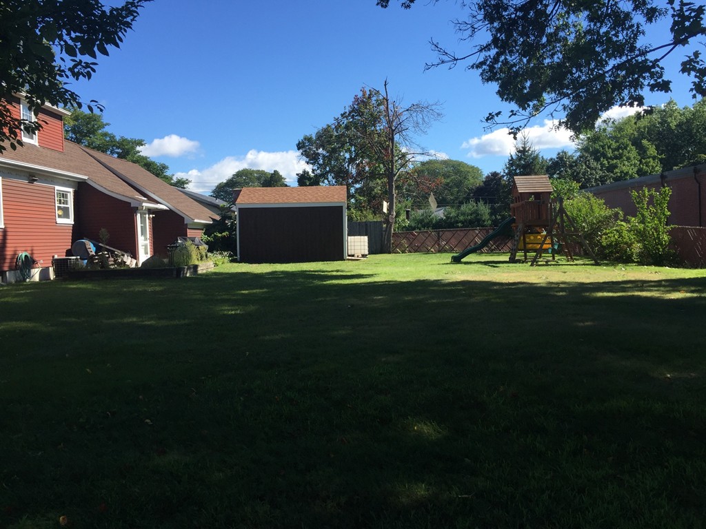 79 Haller Street Springfield, MA 01151 - Photo 12 of 26 a backyard of a house with table and chairs